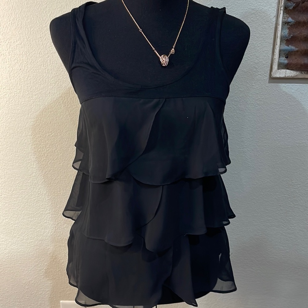 Lauren Conrad black sleeveless ruffled top.
